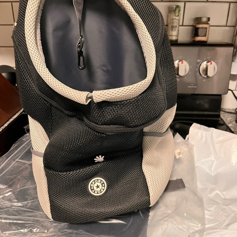 Portable new doggie backpack. Medium dog size. Oxford style. Pockets.Harness